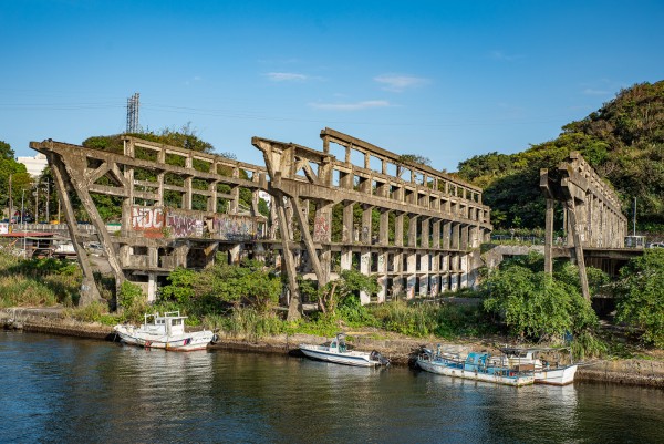 The skeleton of a large building just out onto a river
